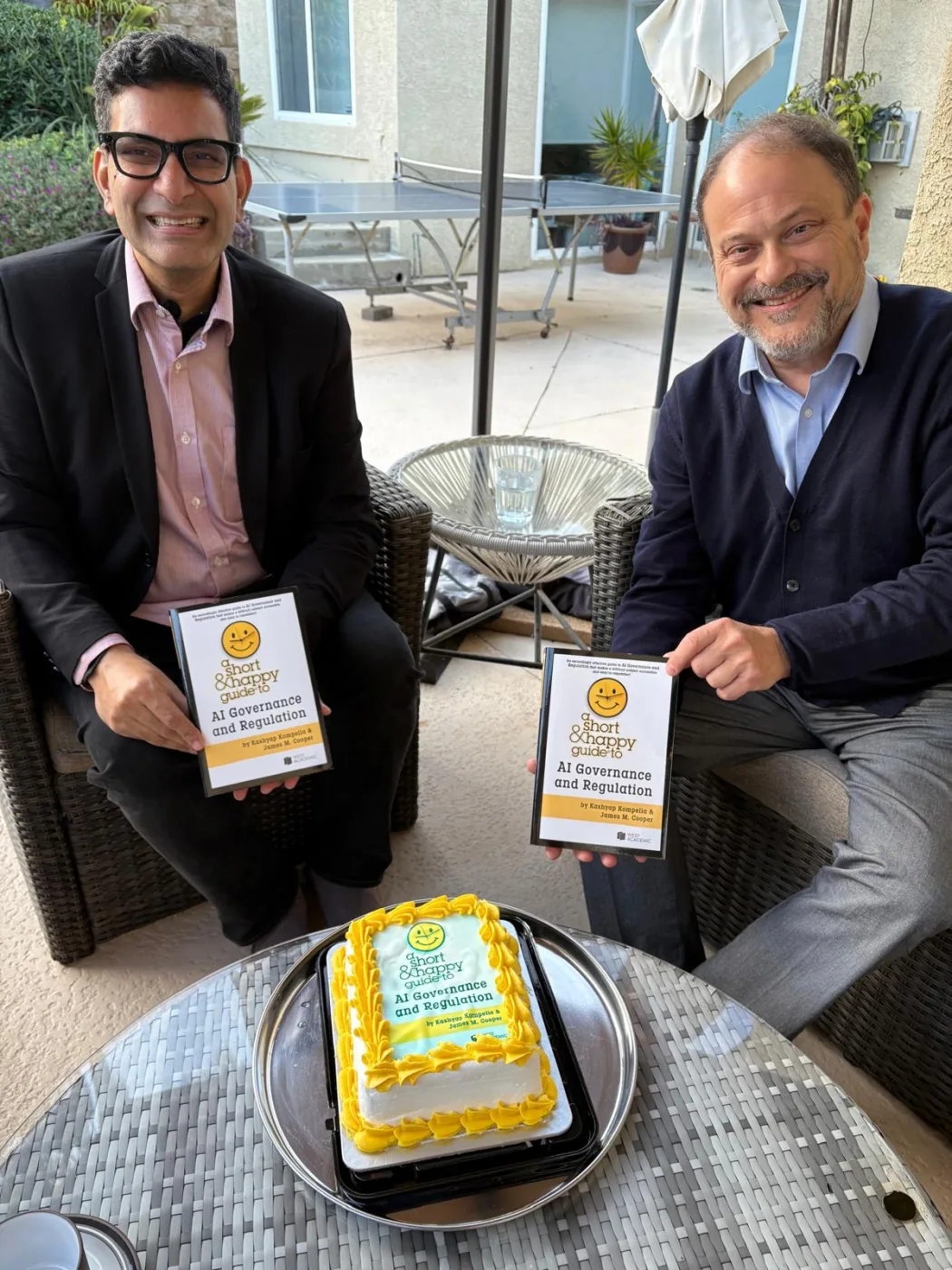 Kashyap Kompella and James M. Cooper with their AI law books