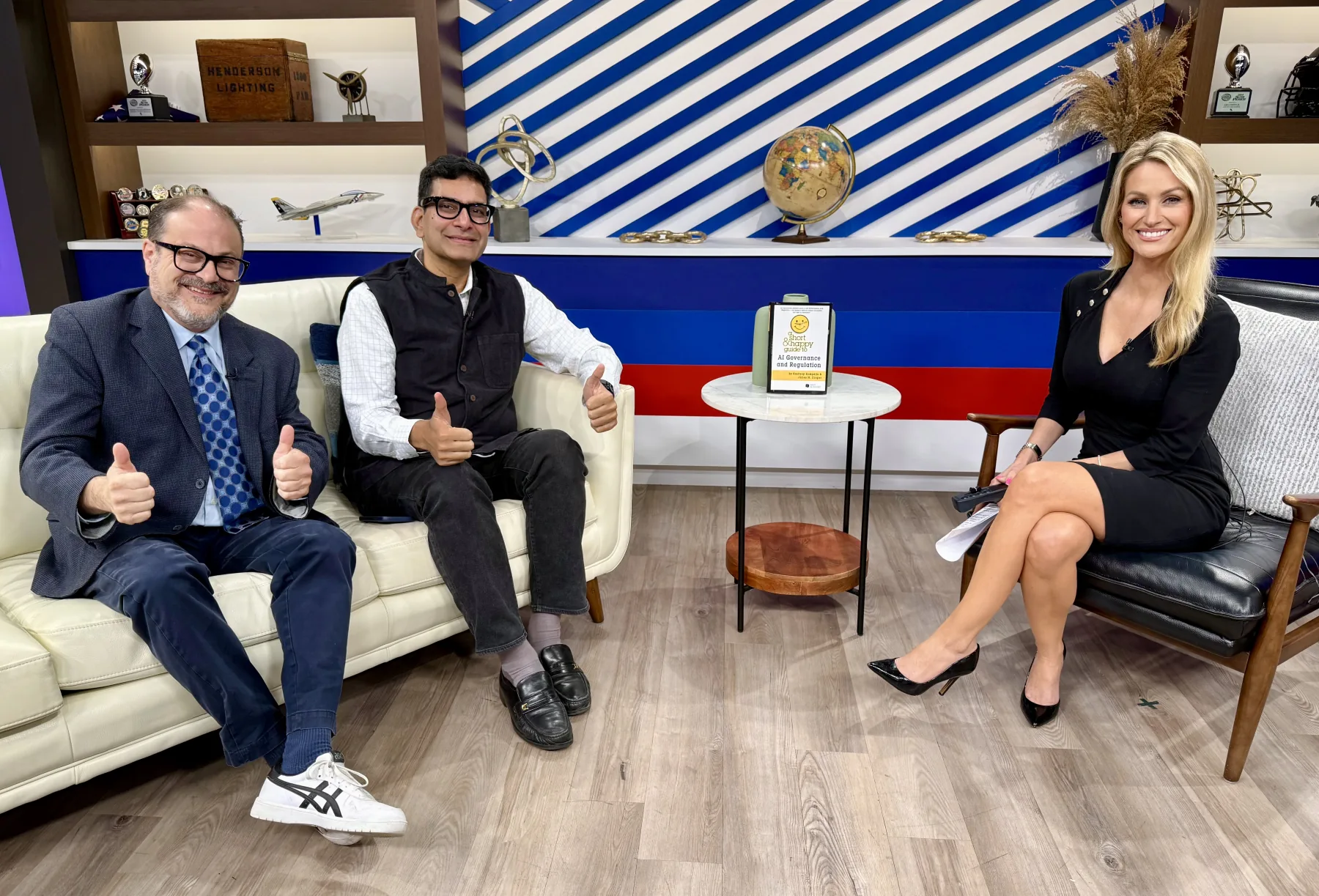 Kashyap Kompella, James M. Cooper and a television host in a studio